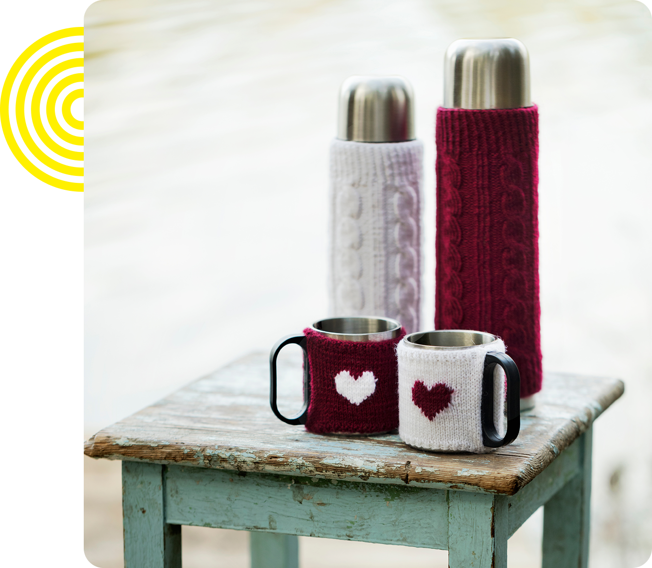 Thermoses and mugs with heart knit covers.