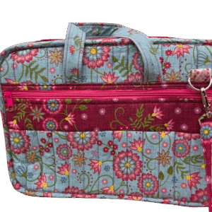 Colorful floral-patterned fabric bag with multiple compartments and zippers.