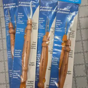 Four wooden crochet hooks in blue packaging, labeled with sizes and ergonomic grips.