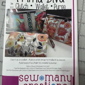 Three colorful clutch wallets with floral and geometric designs.